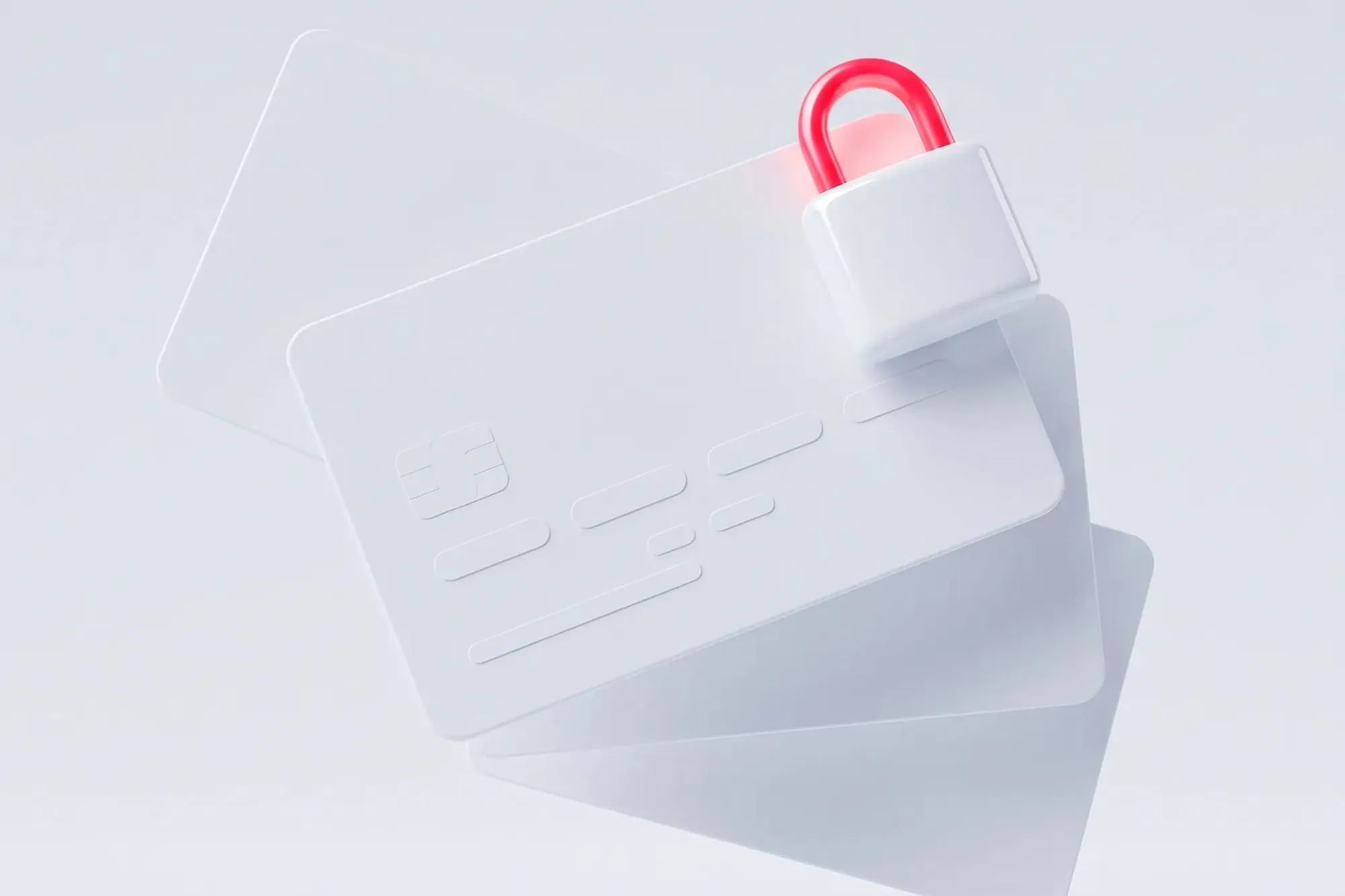 Two white credit cards with a small red-and-white padlock resting on them.