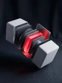 Two white cubes pulled apart to reveal stacked grey layers with a glowing red one inside.
