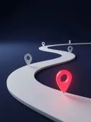 Winding white 3D road with white map pins and one glowing red pin on dark blue background.