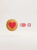 3D cookie with a red heart, an on toggle switch and an empty checkbox on beige.